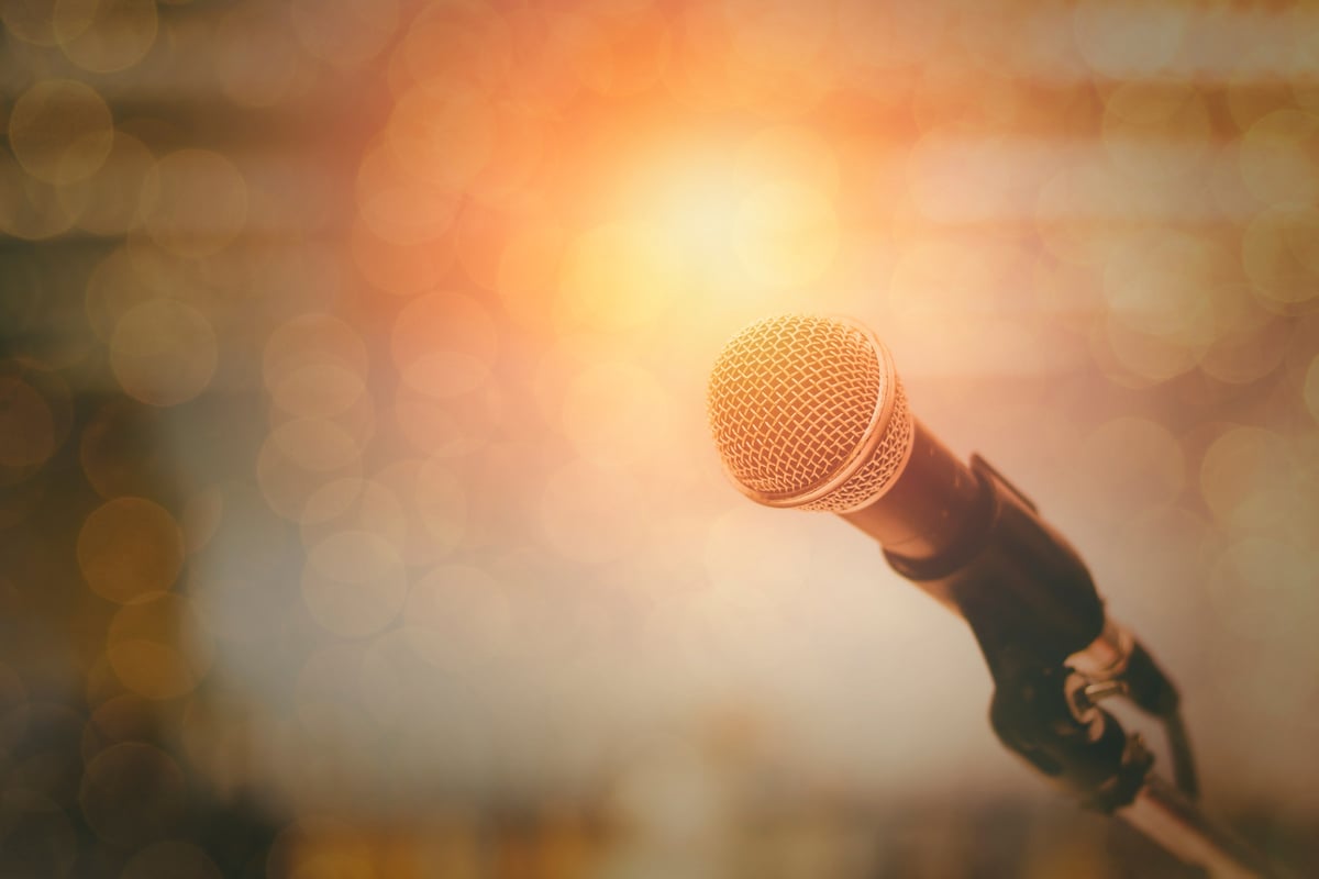 microphone and bokeh background, concept as music instrument in studio room and meeting hall